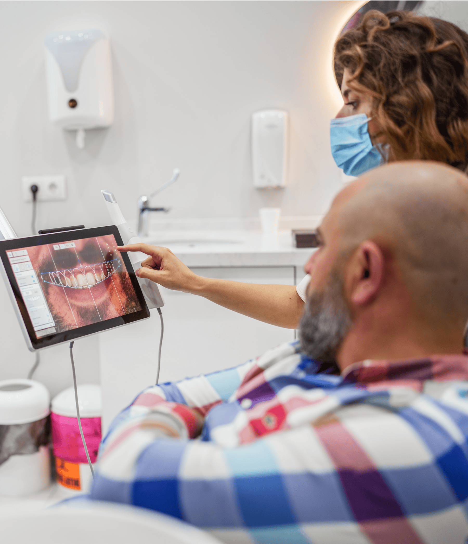Dentist reviewing dental X-ray with patient